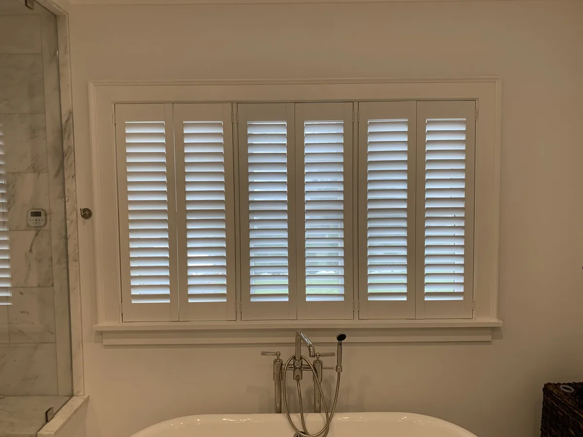Plantation shutters with a hidden tilt bar in a Short Hills bathroom
