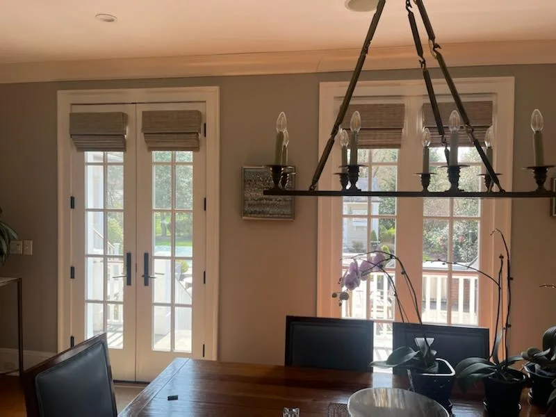 Woven Roman shades on French doors in a Rumson dining room