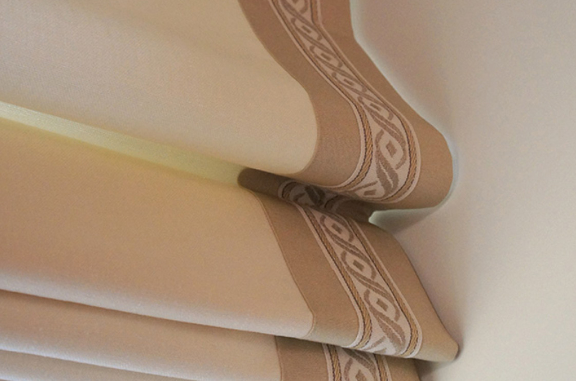 Close-up of custom Roman shade fabric and pleat detail