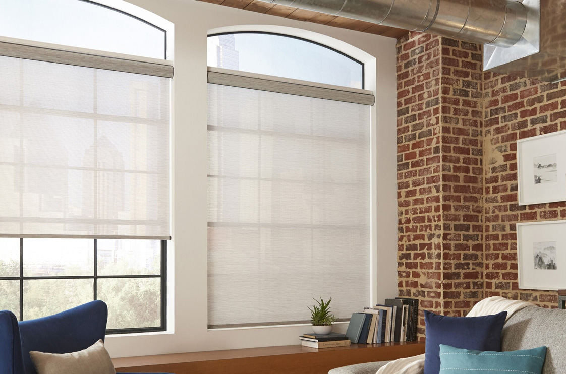 Dual roller shade system in a modern bedroom